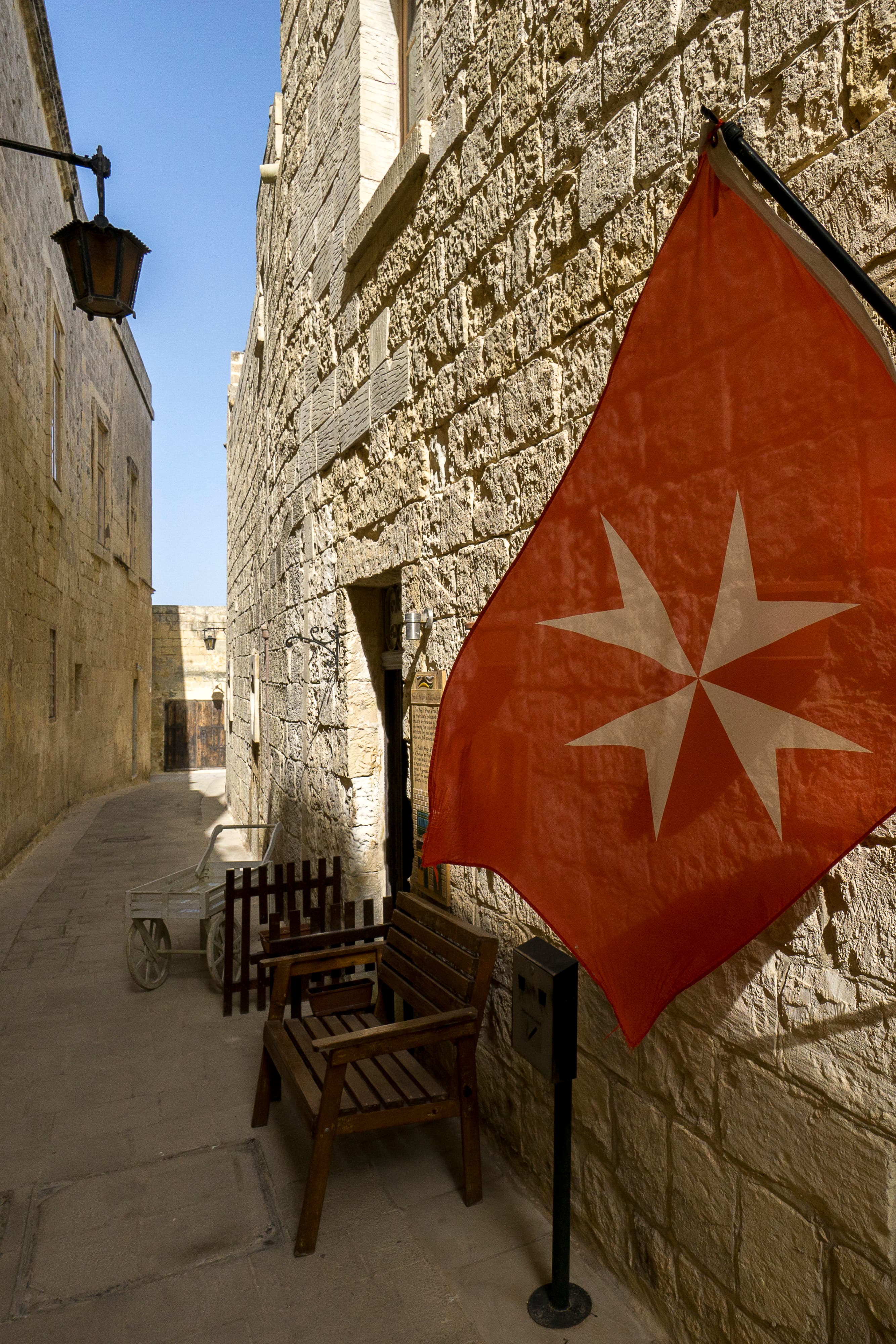 Maltese Cross flag in a limestone alley